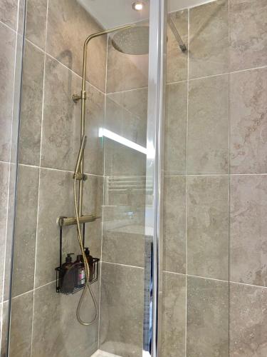 a shower with a glass door in a bathroom at Chez Lima in Lorient