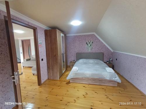 a bedroom with a large bed in a attic at Sheki Dream House in Sheki