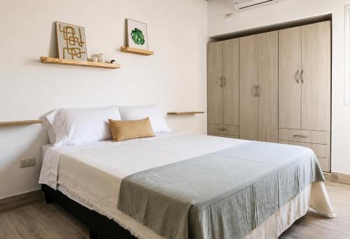 a bedroom with a large bed with white sheets at Casa de los Cerros I - Vaqueros in Vaqueros