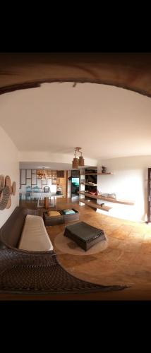 a living room with a couch and a table at Casa Maravilha in Aquiraz
