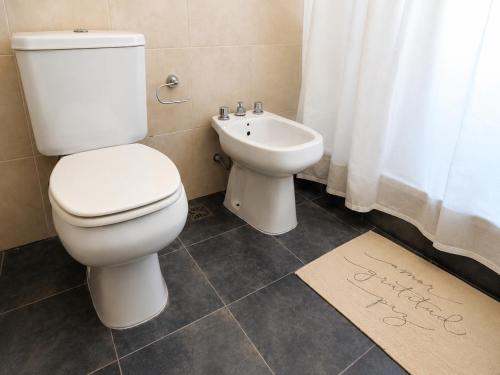 a bathroom with a toilet and a sink at Casa de los Cerros I - Vaqueros in Vaqueros