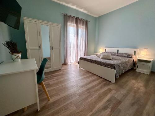 a bedroom with a bed and a wooden floor at La Sabinese in Frasso Sabino