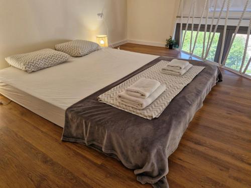 a bed with two folded towels on top of it at 2 4 D2 Mini Condos Studio Loft West facing in Tivat