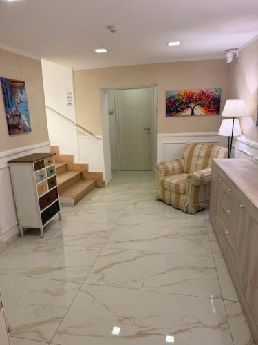a large room with a lobby with a couch and stairs at Mare D'amare in Diamante
