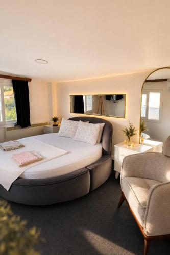 a bedroom with a large bed and a couch at Tepe Hotel in Alaçatı