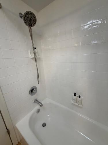 a white bathroom with a tub and a shower at Telluride Creekside Condo 3 Min to Chair 7 in Telluride