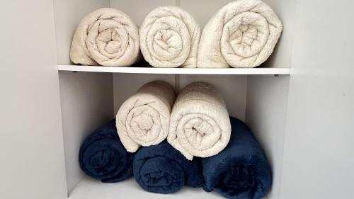 a bunch of towels on shelves in a closet at Casa Marinho - Pé na praia in Saquarema