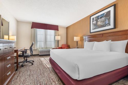 a hotel room with a bed and a desk at Drury Inn & Suites St. Louis Forest Park in Saint Louis