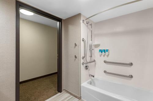 a bathroom with a tub and a shower stall at Drury Inn & Suites Joplin in Joplin