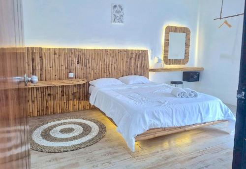 a bedroom with a large bed and a mirror at Altura Esthetic Villas in Bokor