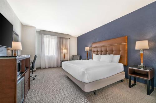 a hotel room with a bed and a television at Drury Plaza Hotel Flagstaff in Flagstaff