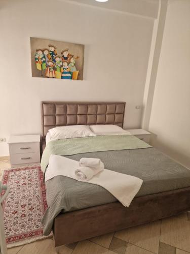 a bedroom with a bed with two towels on it at Villa Noah in Berat
