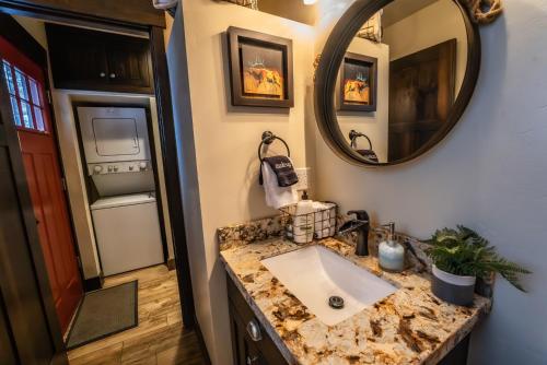 a bathroom with a sink and a mirror at Hideaway Above The Stream Sundance, Utah in Sundance