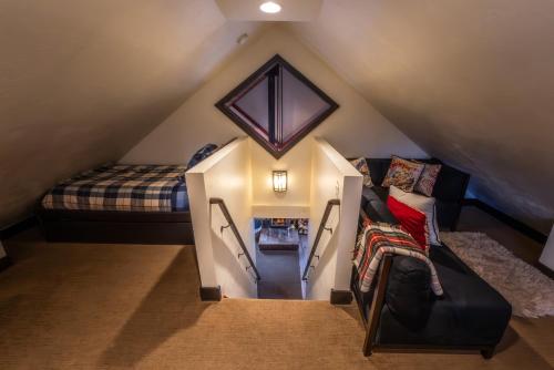 a attic room with a bed and a couch at Hideaway Above The Stream Sundance, Utah in Sundance