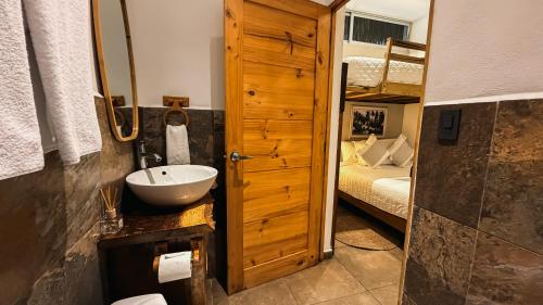 a bathroom with a sink and a bunk bed at Hotel Michanti in El Zonte