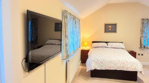 a bedroom with a bed and a flat screen tv at Seaview Inn in Southport