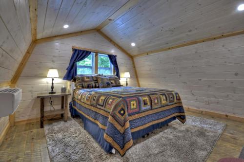 a bedroom with a bed in a log cabin at Ocoee Cottage Water Front in Copperhill