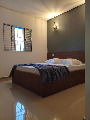 a large bed in a bedroom with a window at Hotel Matarazzo in São Paulo