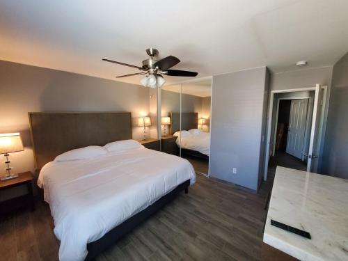 a bedroom with a large bed and a ceiling fan at Family 4BR Home with Spacious Backyard in Coachella