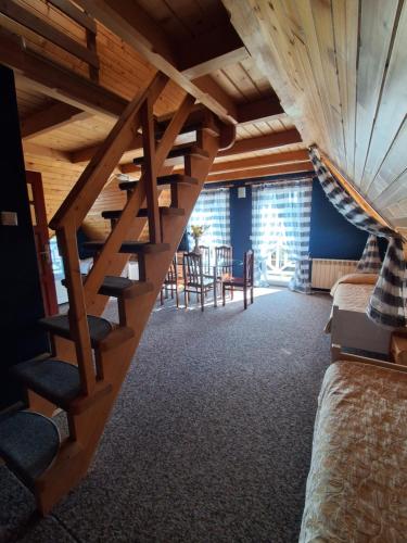 a room with a wooden staircase in a house at Eleni Pokoje Gościnne in Bukowina Tatrzańska