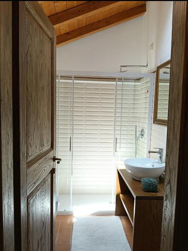 a bathroom with a white sink and a mirror at Casa Il Borgo 1 in Tavernelle