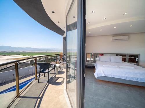 a bedroom with a bed on a balcony at Villa Ocak 1 in Kaş