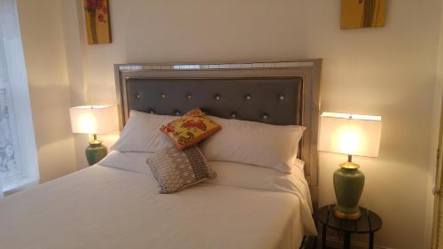 a bedroom with a bed with two lamps on it at Tiffini in New York