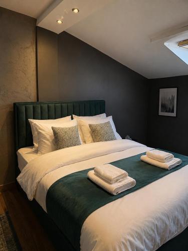 a bedroom with a large bed with two towels on it at The Skyline Suite in Florina