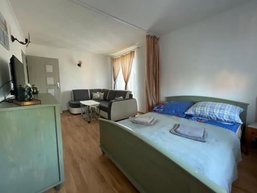 a bedroom with a bed and a living room at Paulo in Golenice