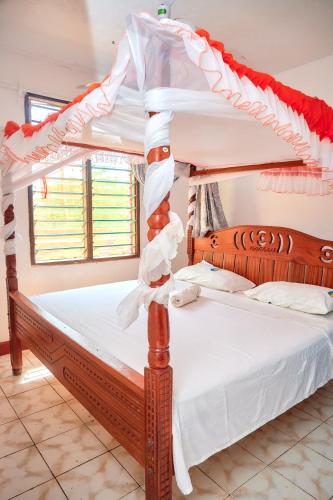 a couple of bunk beds in a room at Tranquil Terrace Cottages Diani in Diani Beach