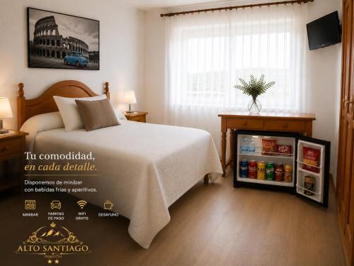 a bedroom with a bed and a small refrigerator at Alto Santiago in San Vicente de la Barquera