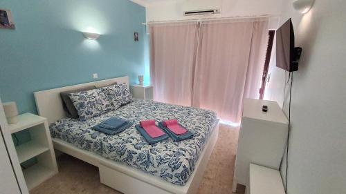 a bedroom with a bed with two shoes on it at Da Rocha Beach 8, SEA VIEW in Portimão