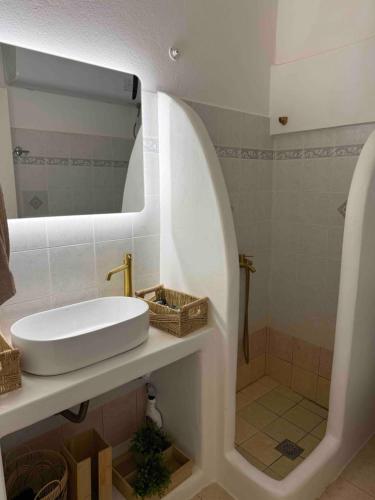 a bathroom with a sink and a shower at Villa Guerini in Astypalaia