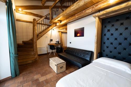 a bedroom with a bed and a staircase at Etna Quota Mille Boutique Hotel, Typical Sicilian Food & Wine in Randazzo