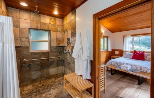 a bedroom with a shower and a bed in a room at Green Springs Inn in Ashland