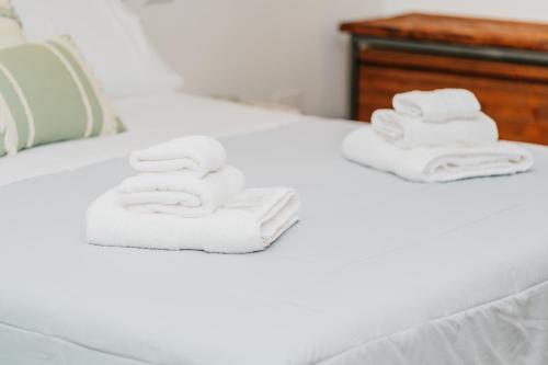 two towels are stacked on a bed at Gattoni Suite by Rentbeat in Martina Franca