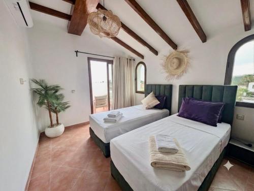 two beds in a room with two windows at Andalucia Family-Only Aparthotel in Cabo Negro
