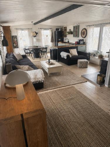 a living room with a couch and a table at Hjartarstaðir Private Country Retreat with Hot Tub in Hagi
