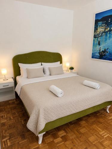 a bedroom with a large bed with two pillows at Apartment M in Višegrad