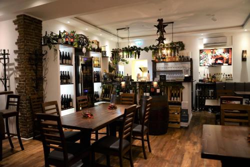 ein Restaurant mit einem Holztisch und Stühlen sowie einer Bar in der Unterkunft Hotel Baden in Bonn