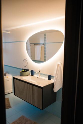 a bathroom with a sink and a mirror at Exclusive Villa with Pool in Káto Ássos