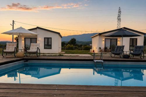 a house with a pool in front of a building at Etno Lux Isaković in Ulcinj