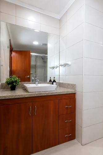 a bathroom with a sink and a mirror at THE VIEW AT RIVEFRONT by Bahama Rentals in Guayaquil