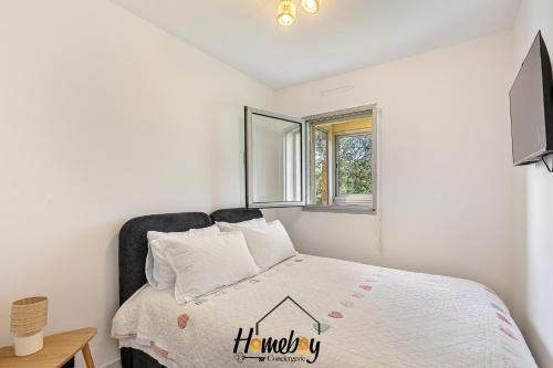 a bedroom with a bed and a window at Les Jardins, Golfe-Juan in Vallauris