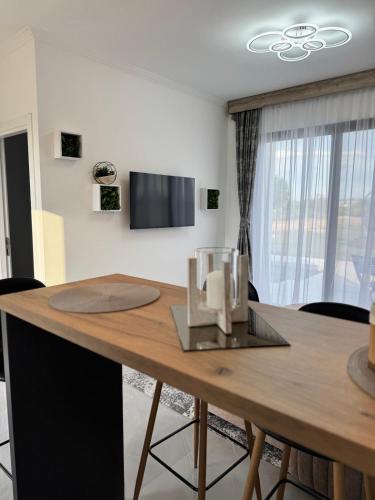 a dining room with a wooden table with chairs at Etno Lux Isaković in Ulcinj