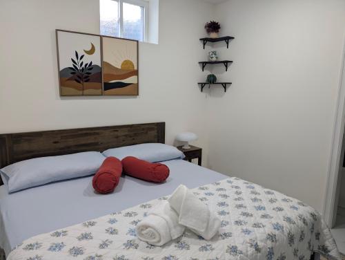 a bedroom with a bed with red and white pillows at Modern Comfort - Minimal Style in Elmont