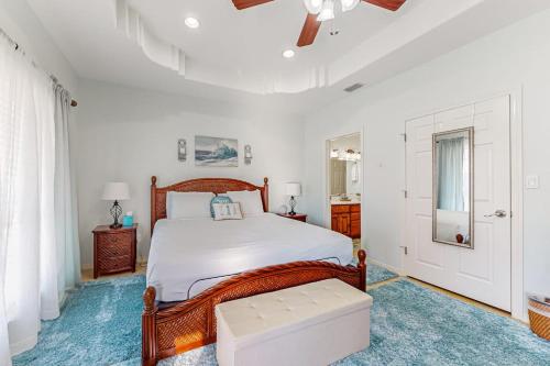 a bedroom with a bed and a ceiling fan at Sunset Over Paradise in South Padre Island