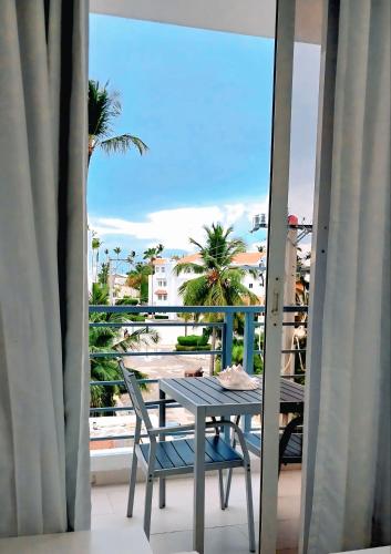 a table and chairs on a balcony with a view of the ocean at Beach Pool Hotel Punta Cana in Punta Cana