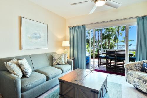 a living room with a couch and a table at Crystal Waters - 2BR 2-5BA Coastal Villa in Duck Key