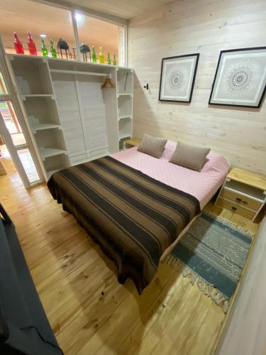 a bedroom with a large bed in a room at forest house - Cabaña para 4 in Pichilemu